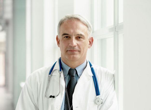 Doctor with a stethoscope in a bright clinic corridor | Doctor in Icmeler | Online Doctor | E-rx.online