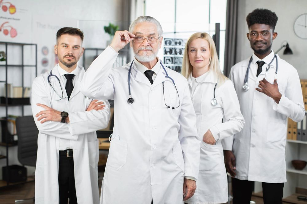 Need a Doctor in Sirkeci? Video Consultation and | Online Prescription | Four doctors in white coats in a medical office | E-rx.online