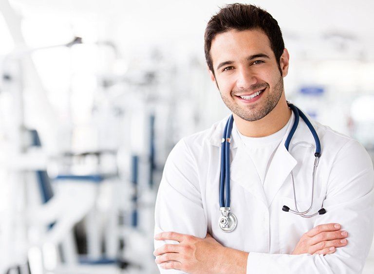 Smiling male doctor with a stethoscope and arms crossed | Doctor in Kiris | Online Doctor & Online Prescription | E-rx.online